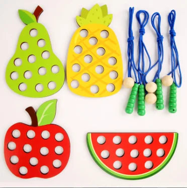 Wooden fruit threading board placed in Montessori early education threading game