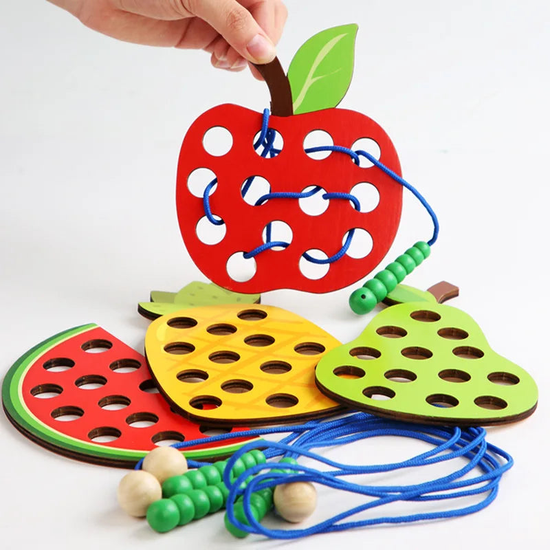 Wooden fruit threading board placed in Montessori early education threading game